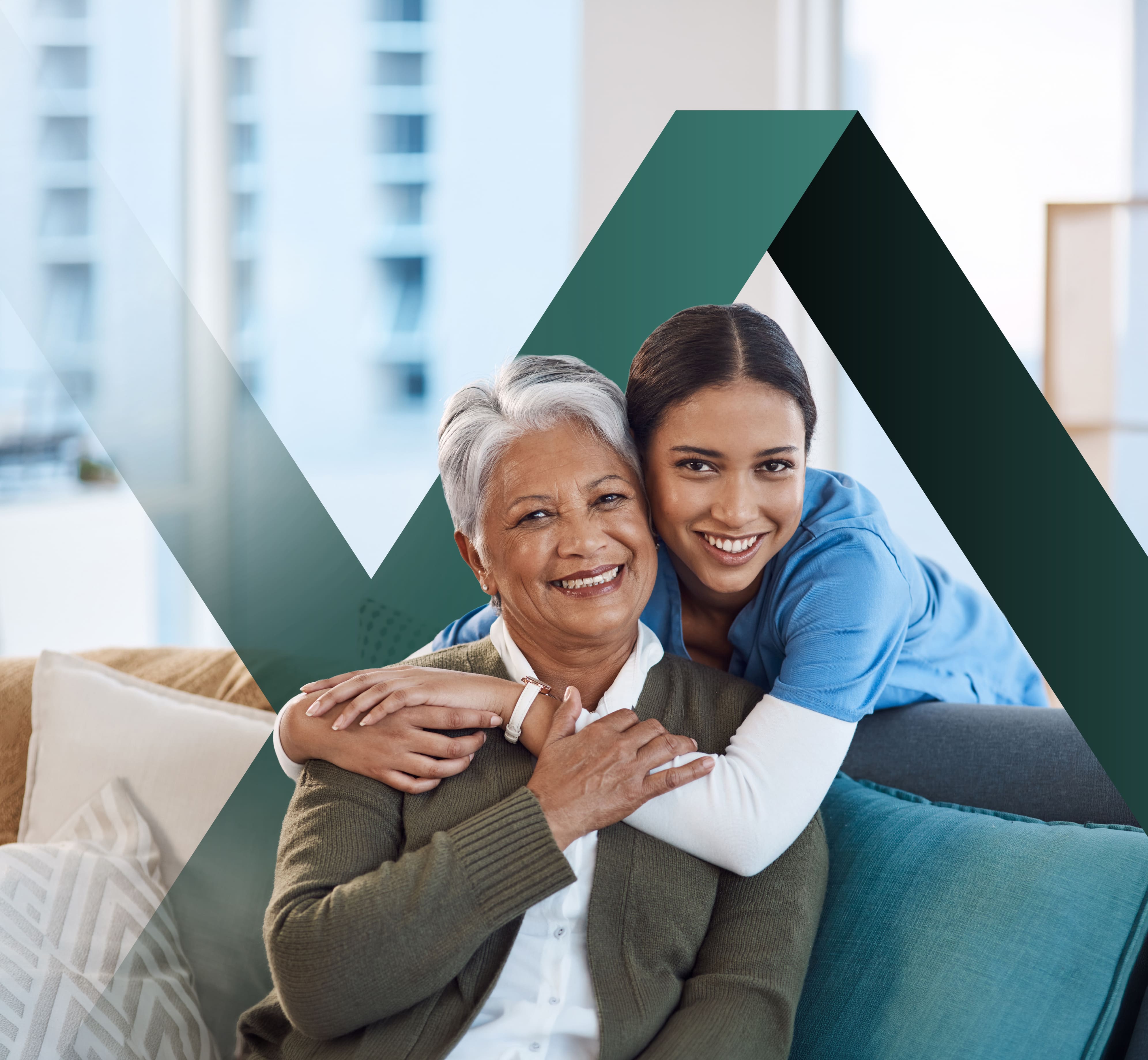 A caregiver embracing a smiling senior woman at home